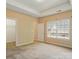 A cozy, carpeted bedroom offers natural lighting and closet, with a view of the outside neighborhood at 11209 Lazio Ln # 1, Charlotte, NC 28277