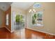 Open dining room with hardwood flooring, natural light from large windows and sliding door access to the patio at 11209 Lazio Ln # 1, Charlotte, NC 28277