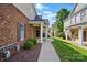 Brick townhome featuring a covered entrance and manicured landscaping at 11209 Lazio Ln # 1, Charlotte, NC 28277