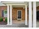 Inviting entrance with stately columns and a stylish black door at 11209 Lazio Ln # 1, Charlotte, NC 28277