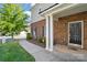 Brick townhome entrance with manicured landscaping and walkway at 11209 Lazio Ln # 1, Charlotte, NC 28277