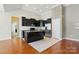 A sleek, modern kitchen featuring granite counters, dark cabinetry, stainless steel appliances and tile flooring at 11209 Lazio Ln # 1, Charlotte, NC 28277