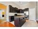 A bright kitchen featuring an island, granite countertops, dark cabinetry, and stainless steel appliances at 11209 Lazio Ln # 1, Charlotte, NC 28277