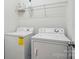 Functional laundry room features modern washer and dryer with overhead storage shelves at 11209 Lazio Ln # 1, Charlotte, NC 28277