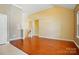 Open living room featuring hardwood floors, neutral walls, and natural light from large windows at 11209 Lazio Ln # 1, Charlotte, NC 28277