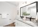 Bathroom boasts double granite vanity with black fixtures and framed mirror, adding style and convenience at 1129 Thayer Glen Ct, Charlotte, NC 28213