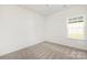 Bright bedroom features neutral carpet and a window, offering a cozy and inviting space at 1129 Thayer Glen Ct, Charlotte, NC 28213