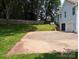Large backyard with a concrete patio, grassy lawn, and a light blue house at 117 Blackberry Ln # 66, Mooresville, NC 28117