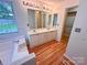 Bright bathroom with a double sink vanity, large mirrors, and a bathtub at 117 Blackberry Ln # 66, Mooresville, NC 28117