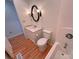 Cozy bathroom featuring wood flooring, a single sink vanity, and a toilet at 117 Blackberry Ln # 66, Mooresville, NC 28117