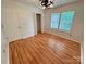 Bedroom featuring wood flooring, two windows with natural light, and a closet at 117 Blackberry Ln # 66, Mooresville, NC 28117