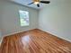 Bright bedroom featuring wood flooring, a ceiling fan, and a window with natural light at 117 Blackberry Ln # 66, Mooresville, NC 28117