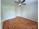 Bedroom features a ceiling fan, two closets, and hardwood flooring at 117 Blackberry Ln # 66, Mooresville, NC 28117
