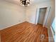 Bright bedroom featuring wood flooring, a closet, and a contemporary ceiling light at 117 Blackberry Ln # 66, Mooresville, NC 28117