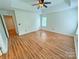 Large bedroom featuring wood flooring, a tray ceiling, a fan, and one window at 117 Blackberry Ln # 66, Mooresville, NC 28117