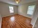 Inviting bedroom with natural light from two windows and featuring wood flooring and a ceiling fan at 117 Blackberry Ln # 66, Mooresville, NC 28117