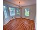 Dining area features hardwood floors, chandelier, and lots of natural light from the bay windows at 117 Blackberry Ln # 66, Mooresville, NC 28117