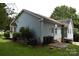 Back exterior view highlighting the home's siding, small porch area, and backyard features at 117 Blackberry Ln # 66, Mooresville, NC 28117