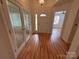 Inviting foyer with wood flooring, decorative glass doors, and a clear view into the living spaces at 117 Blackberry Ln # 66, Mooresville, NC 28117
