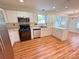 Bright kitchen with stainless steel appliances, white cabinetry, and hardwood flooring at 117 Blackberry Ln # 66, Mooresville, NC 28117