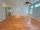 Spacious living room with wood flooring, a ceiling fan, and view of the stairway, offering a versatile layout at 117 Blackberry Ln # 66, Mooresville, NC 28117