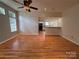 Open living area with wood floors, a ceiling fan, and a seamless transition to the kitchen for modern living at 117 Blackberry Ln # 66, Mooresville, NC 28117