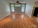 Spacious living room with natural light, wood floors, and a ceiling fan, creating a comfortable atmosphere at 117 Blackberry Ln # 66, Mooresville, NC 28117