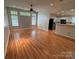 Bright living room with wood floors, a ceiling fan, and an open layout leading to a kitchen with white cabinets at 117 Blackberry Ln # 66, Mooresville, NC 28117