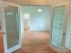 Living room with hardwood floors and view into bright kitchen at 117 Blackberry Ln # 66, Mooresville, NC 28117