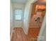 Mudroom features a door to the backyard and a doorway into the laundry area with wood-look floors at 117 Blackberry Ln # 66, Mooresville, NC 28117