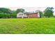 Spacious backyard with lush green grass and mature trees; perfect for outdoor activities at 1184 Cambridge Dr, Shelby, NC 28152