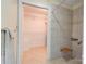 Tiled walk-in shower including seating and accessibility bars, with adjacent closet at 1184 Cambridge Dr, Shelby, NC 28152