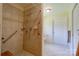 Tiled bathroom with walk-in shower including grab bars for accessibility and safety at 1184 Cambridge Dr, Shelby, NC 28152