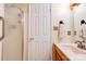 A clean bathroom featuring a walk in shower, tiled floors, and a modern sink with a decorative towel rack at 1184 Cambridge Dr, Shelby, NC 28152