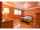 The bedroom has a wooden bed frame, wood floors, and a chandelier for a touch of elegance at 1184 Cambridge Dr, Shelby, NC 28152