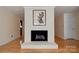Cozy living room featuring a white brick fireplace, hardwood floors, and crown molding at 1184 Cambridge Dr, Shelby, NC 28152