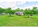 Beautifully landscaped front yard with mature trees and well-manicured lawn at 1184 Cambridge Dr, Shelby, NC 28152