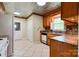 A well-lit kitchen showcases wooden cabinetry, tiled floors, and modern appliances at 1184 Cambridge Dr, Shelby, NC 28152