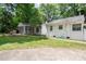 Large backyard with mature trees, screened porch, and patio area for outdoor enjoyment at 1184 Thornwell Ave, Rock Hill, SC 29732