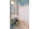 Bathroom featuring blue floral wallpaper, a vessel sink, mosaic tile floor, and a framed mirror for a serene finish at 1184 Thornwell Ave, Rock Hill, SC 29732