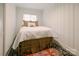 Quaint bedroom featuring a metal-framed bed, vintage rug, and striped wallpaper at 1184 Thornwell Ave, Rock Hill, SC 29732