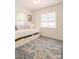 Bright bedroom featuring a daybed with blue pillows, natural light, and a patterned blue and grey rug at 1184 Thornwell Ave, Rock Hill, SC 29732