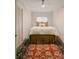 A cozy bedroom with a metal-framed bed, decorative rug, striped wallpaper and white trim at 1184 Thornwell Ave, Rock Hill, SC 29732