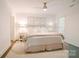 Bright bedroom features neutral decor, a ceiling fan, and a comfortable bed with decorative pillows and floral-patterned throw at 1184 Thornwell Ave, Rock Hill, SC 29732