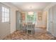 A bright dining room with herringbone floors, table, chairs and a large window for natural light at 1184 Thornwell Ave, Rock Hill, SC 29732