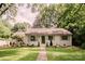 Charming one-story home with a lush green lawn and mature trees providing shade at 1184 Thornwell Ave, Rock Hill, SC 29732