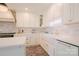 Bright kitchen showcasing white cabinetry, marble countertops, brass hardware, and a farmhouse sink at 1184 Thornwell Ave, Rock Hill, SC 29732