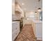 A view of the white kitchen showing the island, range, and dining area with lots of natural light at 1184 Thornwell Ave, Rock Hill, SC 29732