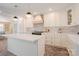 A spacious white kitchen featuring a central island, marble countertops, and a black gas range at 1184 Thornwell Ave, Rock Hill, SC 29732