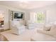Bright living room featuring built-in shelves, a large window with shutters, and matching white sofas with light green pillows at 1184 Thornwell Ave, Rock Hill, SC 29732